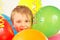 Little boy with holiday balloons and streamer
