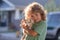 Little boy hugging a dog. Happy child and dog hugs her with tenderness smiling. Kid lovingly embraces his pet dog