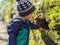 A little boy investigates a hole in the wall