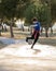 Little boy Juggling soccer ball in nature. Child Kicking Ball. Football Player on practicing in urban nature