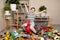 A little boy is jumping on an inflatable rubber donkey among the mess in the children's room. Bouncing toy for kids.