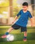 Little boy kicking a soccer ball in sport training session with motion blur and light effect