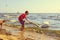 Little boy kid on beach have fun feeding swan.