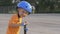 Little boy kid, child in orange t-shirt and blue helmet is riding scooter. Childhood memories, safe and funny experience .