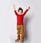 Little boy kid child, stylish hairstyle in sunglasses, red jumper smiling spread hands, pointing fingers showing tongue posing