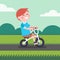 Little boy kid riding bicycle on a park bike path