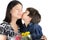 Little boy kissing his mother with flower