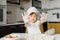 Little boy in kitchen.Cute boy wears a chef hat and apron