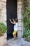 Little boy, knocking on a old medieval door in an old village in