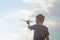 Little boy launches a toy plane into the air. Child launches a toy plane