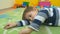 Little boy laying on the floor and playing with car