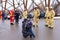 Little boy leaning on his mother looking up at crew of firemen and policewoman