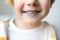 Little boy is learning carefully brush teeth. Child using liquid for disclosing plaque. Teaching children proper oral hygiene.