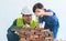 Little boy learning how to lay down brick work from his builder father