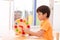 Little boy learning time with clock toy of montessori educational materials