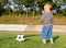 Little boy learning to play soccer