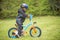 Little boy learning to ride first bike