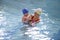 Little boy learns to swim in an individual lesson with a trainer