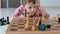 Little boy lies on the floor and plays chess