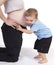 Little boy listening to mom\'s pregnant belly