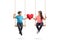 Little boy and a little girl on a swing holding a red heart and looking at each other
