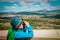 Little boy looking through binocular on travel in nature