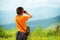 Little boy looking through binoculars outdoor. He is lost.