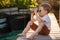 Little boy looking through binoculars on river bank