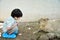 Little boy looking the capybara eating bamboo leaf