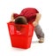 Little boy looking deep into garbage bin