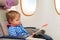 Little boy looking at safety instruction in flight
