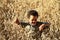 Little boy lost in a field of wheat