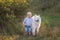 Little boy lovingly embraces white fluffy Samoyed dog. Friendship between man and animal. Traveling