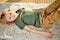 Little boy lying on carpet floor at home, relaxing, having rest alone, side view