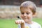 Little Boy Making Funny Face  And Looking Dragonfly