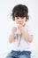 Little boy with medal on his chest sits and drinks juice