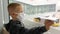 Little boy in a medical mask playing with a paper airplane in airport.