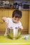 Little boy mixing baking ingredients in a bowl