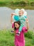 Little boy and mother in autumn nature with colorful balloon.