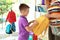 Little boy with mother choosing school backpack in shop