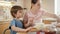 Little boy with mother weighting ingredients for baking pie or cake. Children cooking with parents, little chef, family