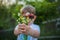 Little boy not in focus holding the flovers presenting the flowers