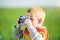 Little boy with an old camera shooting outdoor