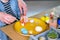 Little boy painting wooden eggs for Easter decoration