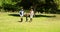 Little boy and parents running towards camera in the park