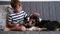 Little boy pet Australian shepherd puppy dog on couch