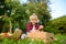 Little boy picking apples in orchard. Child holding straw basket with harvest. Harvesting in the domestic garden in autumn. Fruit