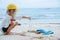 Little boy picks up glass bottle from garbage lying on an ocean shore