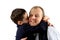 A little boy planting a big kiss on his father\'s cheek