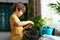 Little boy planting seedlings at home. An independent child is busy with a hobby with potted plants. Lifetime concept